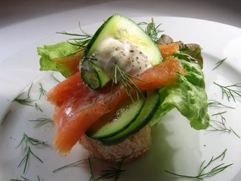 This photo of a healthy and appealing appetizer ... just the sort you'd find at a natural foods restaurant ... of salmon with dill and fresh cucumbers ... was taken by an unknown photographer.